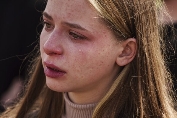 A woman cries during a funeral ceremony for Tamara Martyniuk, 8, Stanislav Martyniuk, 12, and Roman Martyniuk, 17, killed in a Russian strike on Sunday, in Korostyshiv, Zhytomyr region, Ukraine, Wednesday, May 28, 2025. (AP Photo/Evgeniy Maloletka)