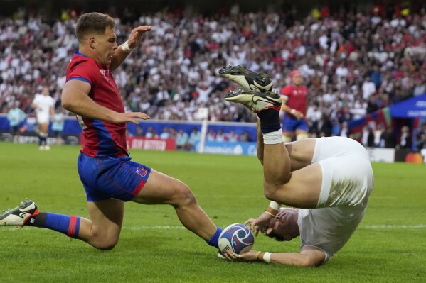 England's Henry Arundell, right, scores a try during the Rugby World Cup Pool D match between England and Chile at the Stade Pierre Mauroy in Villeneuve-d'Ascq, outside Lille, Saturday, Sept. 23, 2023. (AP Photo/Themba Hadebe)