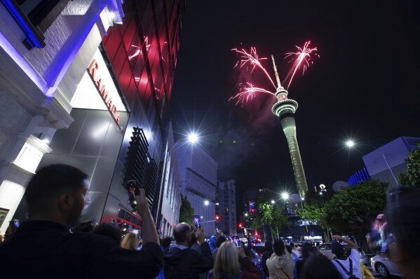 Fireworks burst from the Sky Tower in Auckland, New Zealand, to celebrate the New Year on Monday, Jan. 1, 2024. (Hayden Woodward/New Zealand Herald via AP)