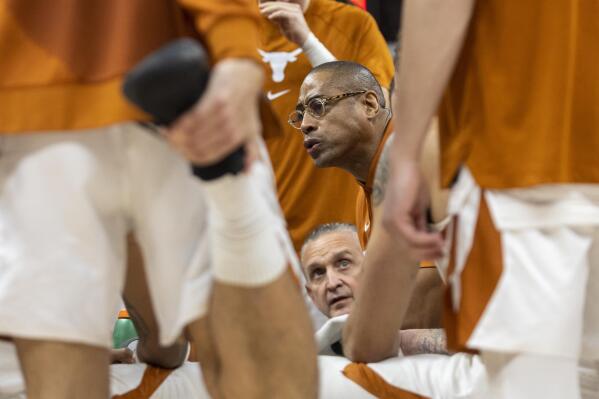 Associate head coach Rodney Terry speaks to his team in a timeout against Rice during the second half of an NCAA college basketball game Monday, Dec. 12, 2022, in Austin, Texas. (AP Photo/Stephen Spillman)