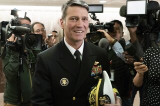 
              Rear Adm. Ronny Jackson, President Donald Trump's choice to be secretary of the Department of Veterans Affairs, leaves a Senate office building after meeting individually with some members of the committee that would vet him for the post, on Capitol Hill in Washington, Tuesday, April 24, 2018.  (AP Photo/J. Scott Applewhite)
            