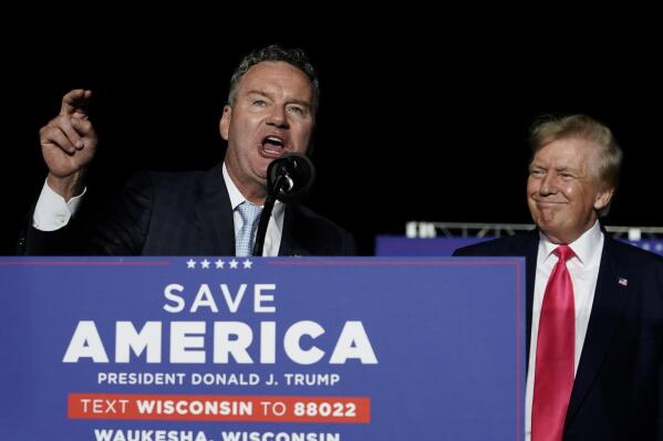 FILE - Wisconsin Republican gubernatorial candidate Tim Michels, left, speaks as former President Donald Trump, right, listens at a rally Aug. 5, 2022, in Waukesha, Wis. Michels casts himself as an outsider, although he previously lost a campaign to oust then-U.S. Sen. Russ Feingold in 2004 and has long been a prominent GOP donor. (AP Photo/Morry Gash, File)