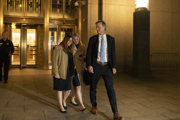 Graham Chase Robinson, center, and her attorneys Alexandra Hardin, left, and Brent Hannafan depart a federal courthouse in New York on Thursday, Nov. 9, 2023. (AP Photo/Peter K. Afriyie)