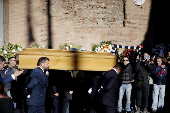 People carry the coffin of former soccer player Sinisa Mihajlovic, ahead of his funeral service, in Rome, Italy, Monday, Dec. 19, 2022. Former soccer player and coach Mihajlovic died at 53 after a long battle with leukemia. Mihajlovic’s family announced Friday that he died in a Rome hospital. (Cecilia Fabiano /LaPresse via AP)