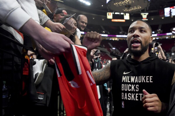 Milwaukee Bucks guard Damian Lillard runs off the court after warmups before an NBA basketball game against the Portland Trail Blazers in Portland, Ore., Wednesday, Jan. 31, 2024. (AP Photo/Steve Dykes)