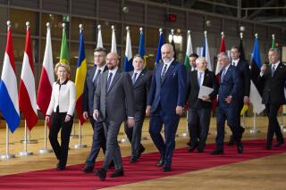 European Council President Charles Michel, right front, and European Commission President Ursula von der Leyen, front left, walk with leaders of the Western Balkans prior to a group photo in Brussels on Feb. 16, 2020. European Union auditors say that the hundreds of millions of funds that the bloc has poured into 6 Western Balkan nations to improve the rule of law there, just doesn't pay off. The report of the European Court of Auditors published Monday shows that overall, the nations concerned, often continue to show a lack of commitment to tackle anything from pervasive corruption to state interference that would help them on the way to the EU membership. (AP Photo/Virginia Mayo, File)
