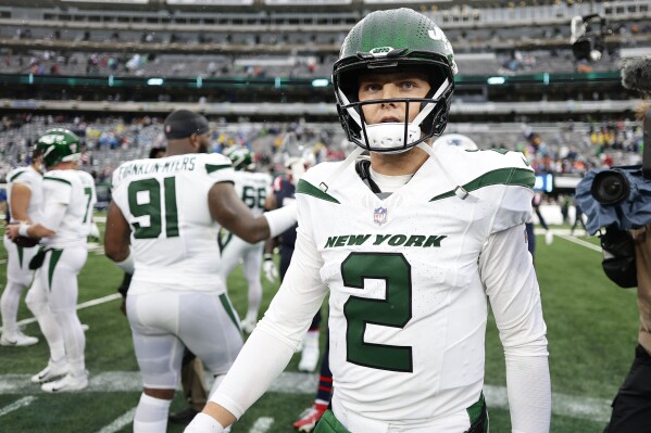 New York Jets quarterback Zach Wilson (2) walks off the field after losing to the New England Patriots in an NFL football game, Sunday, Sept. 24, 2023, in East Rutherford, N.J. (AP Photo/Adam Hunger)