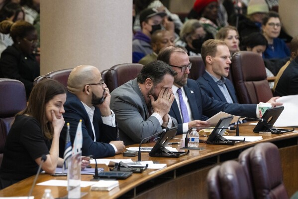 Alderman Anthony Napolitano, center, buries his face in his hands during a City Council meeting to discuss a resolution that would call for a cease-fire in Gaza, Wednesday, Jan. 31, 2024, in Chicago. Chicago’s City Council narrowly approved a resolution Wednesday calling for a permanent cease-fire in the war between Israel and Hamas with Mayor Brandon Johnson casting the tiebreaking vote. (Pat Nabong/Chicago Sun-Times via AP)