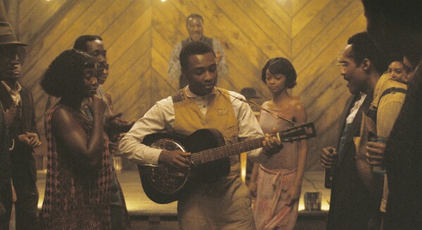 This image released by Warner Bros Pictures shows Miles Caton, center, in a scene from "Sinners." (Warner Bros. Pictures via AP)