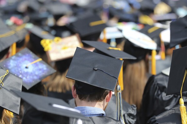 FILE - Graduates at the University of Toledo commencement ceremony in Toledo, Ohio, May 5, 2018. Another 78,000 Americans are getting their federal student loans canceled through a program that helps teachers, nurses, firefighters and other public servants, the Biden administration announced Thursday. The Education Department is canceling the borrowers’ loans because they reached 10 years of payments while working in public service, making them eligible for relief under the Public Service Loan Forgiveness program. (AP Photo/Carlos Osorio, File)