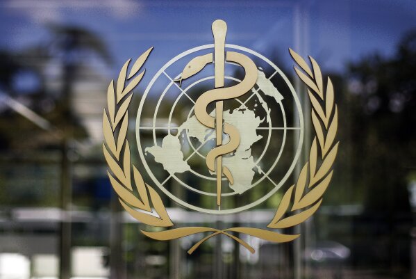 FILE - In this Thursday, June 11, 2009 file photo, the logo of the World Health Organization is seen at the WHO headquarters in Geneva, Switzerland. The World Health Organization has reported a new daily record high in coronavirus cases worldwide, with more than 350, 000 cases reported to the U.N. health agency on Friday, Oct. 9, 2020. The new daily high of 350,766 cases surpasses a record set earlier this week and is nearly 12,000 more infections. (AP Photo/Anja Niedringhaus, file)