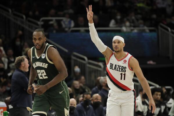 Portland Trail Blazers' Josh Hart (11) shoots over Milwaukee Bucks