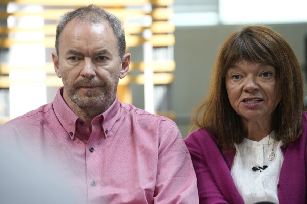FILE - Simon Glass, left, and his wife, Sally Glass, speak, on May 23, 2023, during a news interview in the offices of the couple's lawyers in Denver. One of two Colorado law enforcement officers accused of needlessly escalating a standoff that led to the death of their 22-year-old son pleaded guilty to a misdemeanor on Thursday, Nov. 16 2023 and was sentenced to two years of probation. (AP Photo/David Zalubowski, file)