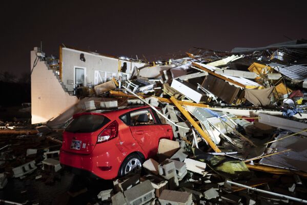 A car is buried under rubble on Main Street after a tornado hit Hendersonville, Tenn., Saturday, Dec. 9, 2023. (Andrew Nelles/The Tennessean via AP)
