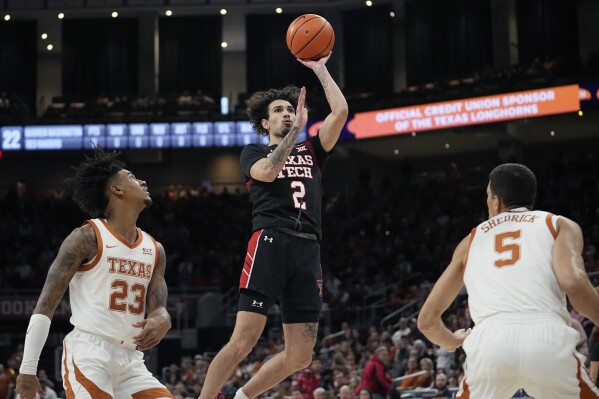 Texas Tech guard Pop Isaacs (2) shoots past Texas forwards Dillon Mitchell (23) and Kadin Shedrick (5) during the first half of an NCAA college basketball game in Austin, Texas, Saturday, Jan. 6, 2024. (AP Photo/Eric Gay)