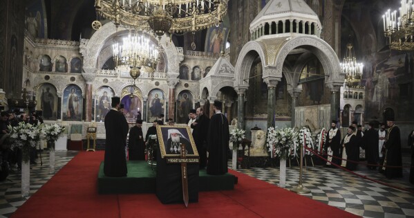 Bulgarian Orthodox Priests pay their last respects to Bulgarian patriarch Neophyte at the Alexander Nevsky Cathedral in Sofia, Friday, March 15, 2024. National mourning was declared by the Bulgarian government on March 15 and 16 to honour Patriarch Neophyte of Bulgaria. Neophyte who was the first elected head of the Orthodox Church in the post-communist Balkan country, died at a hospital in Sofia on March 13. He was 78. .(AP Photo/Valentina Petrova)