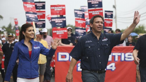 Republican presidential candidate and Florida Gov. Ron DeSantis and his wife Casey, walk in the July 4th parade, Tuesday, July 4, 2023, in Merrimack, N.H. (AP Photo/Reba Saldanha)