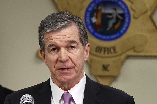 FILE - North Carolina Gov. Roy Cooper speaks at a news conference at the Moore County Sheriff's Office in Carthage, N.C., Monday, Dec. 5, 2022. North Carolina trial judges on Thursday, Nov. 30, 2023, blocked portions of a new law that would transfer Democratic Gov. Roy Cooper’s authority to pick election board members to the Republican-dominated General Assembly. (AP Photo/Karl B DeBlaker, File)