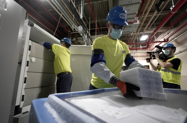 Boxes containing the Pfizer-BioNTech COVID-19 vaccine are prepared to be shipped at the Pfizer Global Supply Kalamazoo manufacturing plant in Portage, Mich., Sunday, Dec. 13, 2020. (AP Photo/Morry Gash, Pool)