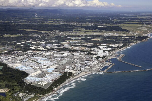 This aerial view shows the tanks, seen foreground, which contain treated radioactive wastewater at the Fukushima Daiichi nuclear power plant in Fukushima, northern Japan, on Aug. 22, 2023. The operator of the tsunami-wrecked Fukushima Daiichi nuclear power plant will begin releasing the first batch of treated and diluted radioactive wastewater into the Pacific Ocean later Thursday, Aug. 24, 2023, utility executives said. (Kyodo News via AP)