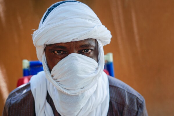 Boubacar Moussa, a former member of the Jama'at Nusrat al-Islam wal-Muslimin group, linked to al-Qaida, poses for a photo in Niamey, Niger, Tuesday, Aug. 1, 2023. The 47-year-old says Niger's coup will embolden violence, increase recruitment across the country and threaten regional stability. (AP Photo/Sam Mednick)