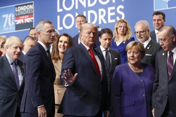 FILE - U.S. President Donald Trump, center, gestures as he walks off the podium after a group photo at a NATO leaders meeting at The Grove hotel and resort in Watford, Hertfordshire, England, Wednesday, Dec. 4, 2019. Trump says he once warned that he would allow Russia to do whatever it wants to NATO member nations that are “delinquent” in devoting 2% of their gross domestic product to defense. Trump’s comment on Saturday represented the latest instance in which the former president and Republican front-runner seemed to side with an authoritarian state over America’s democratic allies. (Peter Nicholls, Pool Photo via AP, File)