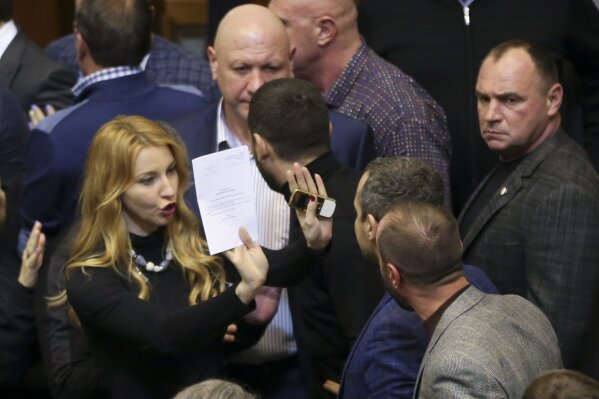
              Ukrainian lawmakers argue between each other during a parliament session in Kiev, Ukraine, Monday, Nov. 26, 2018. Ukrainian parliament has voted to impose martial law for 30 days in wake of Russian seizure of Ukrainian vessels. (AP Photo/Efrem Lukatsky)
            