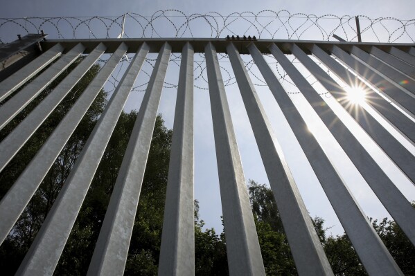 FILE - A metal wall on the border between Poland and Belarus, near Kuznice, Poland, on June 30, 2022. Poland’s president has announced that the country will hold its parliamentary election on October 15. The announcement on Tuesday marks the official start of an electoral campaign that has informally been underway for months and is being shaped by Russia’s war against Ukraine. (AP Photo/Michal Dyjuk, File)