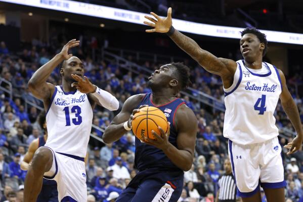 UConn forward Adama Sanogo drives to the basket against Seton Hall forwards KC Ndefo (13) and Tyrese Samuel (4) during the first half of an NCAA college basketball game in Newark, N.J., Wednesday, Jan. 18, 2023. (AP Photo/Noah K. Murray)