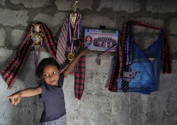 Nirmala Pariyar's sister points to Nirmala's photo on Tuesday, April 1, 2025 about the certificate hanging from the wall of her home in Kathmandu, Nepal.