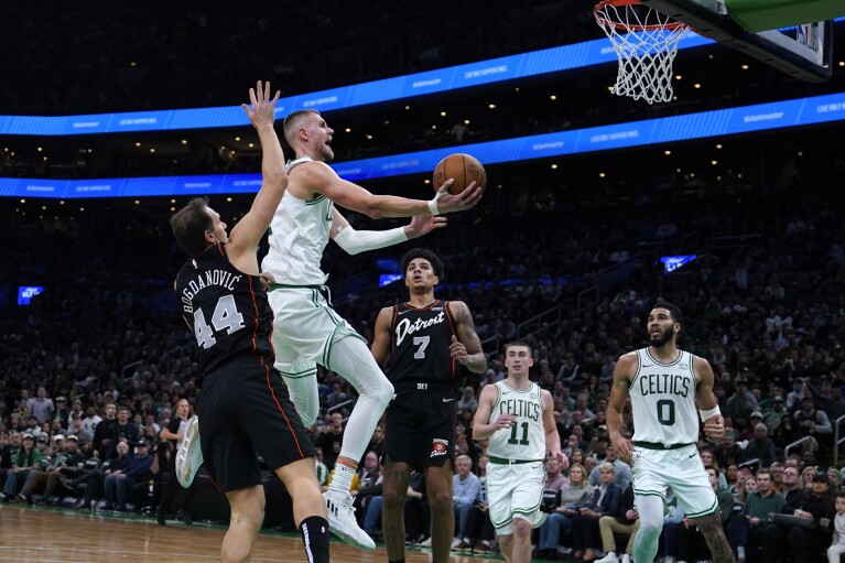 Boston Celtics center Kristaps Porzingis drives to the basket against the Detroit Pistons during the second half of an NBA basketball game, Thursday, Dec. 28, 2023, in Boston. (AP Photo/Charles Krupa)