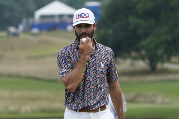 Billy Horschel looks at his ball as he walks off the 15th green after making a birdie putt during the third round of the Wyndham Championship golf tournament in Greensboro, N.C., Saturday, Aug. 5, 2023. (AP Photo/Chuck Burton)