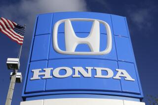 FILE - This Tuesday, Jan. 13, 2015, file photo shows a sign at a Honda dealership in Miami Lakes, Fla. Japanese automaker Honda said Friday, April 23, 2021 that it plans to phase out all of its gasoline-powered vehicles in North America by 2040, making it the latest major automaker with a goal of becoming carbon neutral. The announcement came as leaders of the major global economies met for President Joe Biden's climate summit.  (AP Photo/Alan Diaz, File)