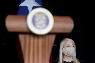 FILE - In this May 21, 2020 file photo, Gov. Wanda Vazquez, wearing a protective face mask amid the new coronavirus pandemic, attends a press conference, in San Juan, Puerto Rico. Vazquez announced Wednesday, Aug. 19, 2020, that she will place the U.S. territory on a 24-hour lockdown every Sunday as part of stricter measures to fight a spike in COVID-19 cases. (AP Photo/Carlos Giusti, File)