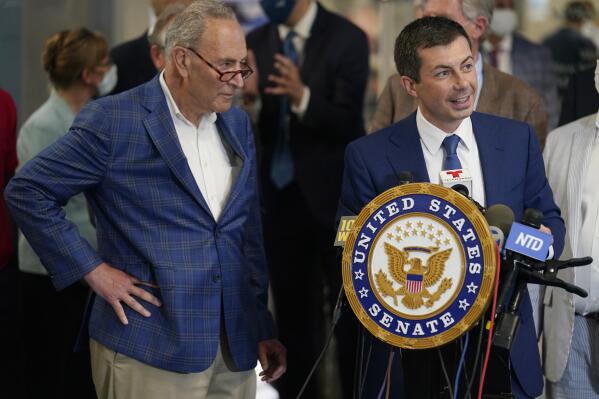Secretary of Transportation Pete Buttigieg, right, and Sen. Chuck Schumer, D-N.Y., take questions during a news conference in New York, Monday, June 28, 2021. Buttigieg toured the century-old rail tunnel connecting New York and New Jersey as a long-delayed project to build a new tunnel gains steam. (AP Photo/Seth Wenig)