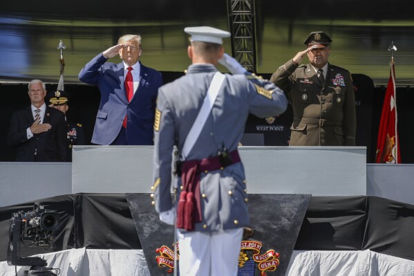 President Donald Trump, left, and the United States Military Academy superintendent Darryl A. Williams, right, salute graduating cadets as the national anthem is played during commencement ceremonies in West Point, N.Y., June 13, 2020. (AP Photo/John Minchillo, Pool, File)