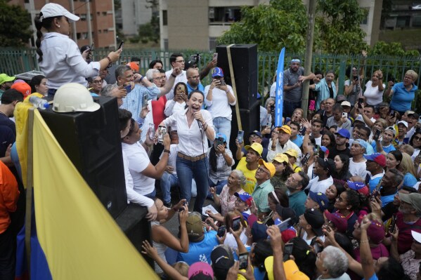 FILE - Opposition leader Maria Corina Machado, who has been banned from running for office, attends a rally where she asked supporters to keep the faith, in San Antonio, Venezuela, April 17, 2024. On Friday, April 20, 2024, all 10 parties in the chief opposition coalition announced they would back an unknown former diplomat, Edmundo González, to be their candidate on the July 28th ballot. (AP Photo/Ariana Cubillos, File)