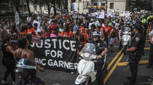 FILE - A rally of mostly young people march in protest against the decision by federal prosecutors not to bring civil rights charges against New York City police officer Daniel Pantaleo for the 2014 chokehold death of Eric Garner, July 17, 2019, in New York. On Monday, Nov. 20, 2023, New York's highest court upheld a New York City law that forbids police from using chokeholds or compressing a person's diaphragm during an arrest, rejecting a challenge from police unions to a law passed after the death of George Floyd. (AP Photo/Bebeto Matthews, File)