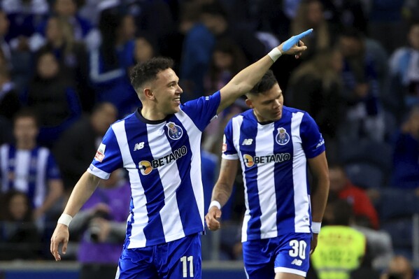 Porto's Pepe, left, celebrates with Evanilson after scoring his side's second goal during a Portuguese league soccer match between FC Porto and Sporting CP at the Dragao stadium in Porto, Portugal, Sunday, April 28, 2024. (AP Photo/Luis Vieira)