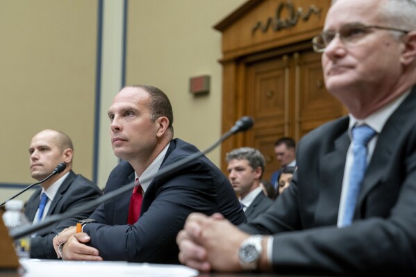 Ryan Graves, Americans for Safe Aerospace Executive Director, from left, U.S. Air Force (Ret.) Maj. David Grusch, and U.S. Navy (Ret.) Cmdr. David Fravor, testify before a House Oversight and Accountability subcommittee hearing on UFOs, Wednesday, July 26, 2023, on Capitol Hill in Washington. (AP Photo/Nathan Howard)
