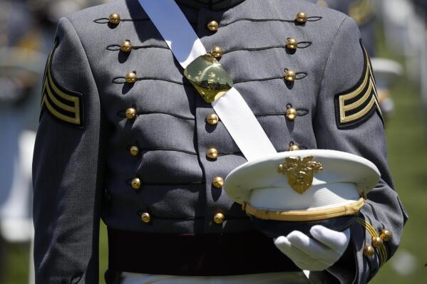 FILE - A Cadet listens during a commencement ceremony for the Class of 2020 on the parade field, at the United States Military Academy in West Point, N.Y., June 13, 2020. U.S. officials say reported sexual assaults at the U.S. military academies increased sharply during the 2020-2021 school year, as students returned to in-person classes amid the ongoing pandemic. The increase continues what officials believe is an upward trend at the academies, despite an influx of new sexual assault prevention and treatment programs.(AP Photo/Alex Brandon, File)