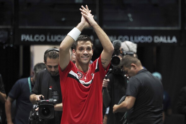 Canada's Alexis Galarneau celebrates after defeating Chile's Alejandro Tabilo during the men's single Davis Cup group A tennis match between Chile and Canada, in Bologna, Saturday Sept. 16, 2023. (Michele Nucci/LaPresse via AP)