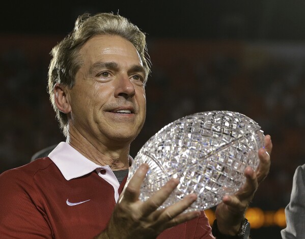 FILE - In this Jan. 7, 2013, file photo, Alabama head coach Nick Saban holds The Coaches Trophy after the BCS National Championship college football game against Notre Dame, in Miami. Nick Saban, the stern coach who won seven national championships and turned Alabama back into a national powerhouse that included six of those titles in just 17 seasons, is retiring, according to multiple reports, Wednesday, Jan. 10, 2024. (AP Photo/David J. Phillip, File)