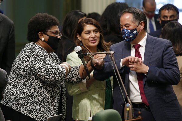 FILE - In this June 10, 2020, file photo, Assemblywoman Shirley Weber, D-San Diego, left, receives congratulations from fellow Assembly members Sharon Quirk-Silva, D-Fullerton, center, and Phil Ting, D-San Francisco, after the Assembly approved her measure to place a constitutional amendment on the Nov. 3, 2020 ballot to let voters decide if the state should overturn its ban on affirmative action programs, at the Capitol in Sacramento, Calif. (AP Photo/Rich Pedroncelli, File)