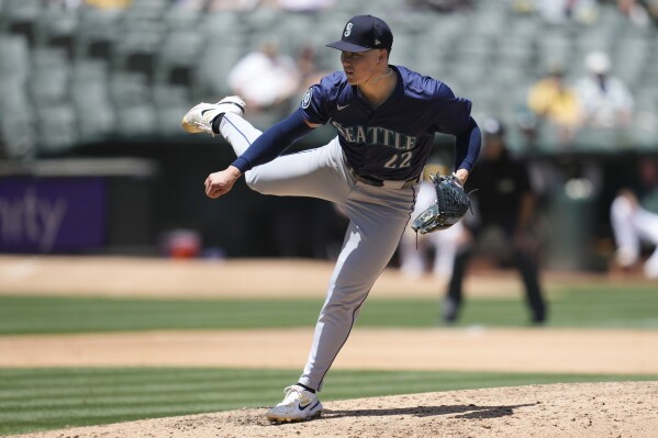 Seattle Mariners pitcher Bryan Woo works against the Oakland Athletics during the fourth inning of a baseball game in Oakland, Calif., Thursday, June 6, 2024. (AP Photo/Jeff Chiu)