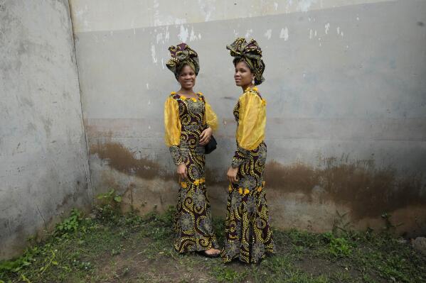Twins Oladapo Taiwo, left, and Oladapo Kehinde, right, 21, pose for photographs during the annual twins festival in Igbo-Ora South west Nigeria, on Saturday, Oct. 8, 2022. The town holds the annual festival to celebrate the high number of twins and multiple births. (AP Photo/Sunday Alamba)