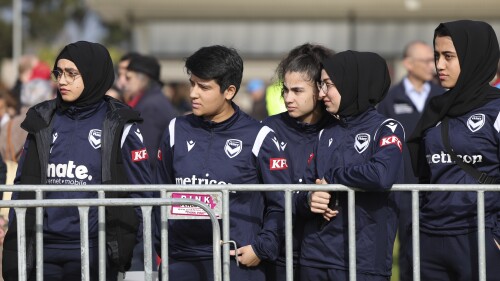 Members of the Afghan women's football team attend Morocco's practice ahead of the Women's World Cup in Melbourne, Australia, Wednesday, July 19, 2023. Some of the team left Afghanistan after the Taliban retook power in 2021 and came out to support the Moroccan women and show that Muslim women belong in sports. (AP Photo/Victoria Adkins)