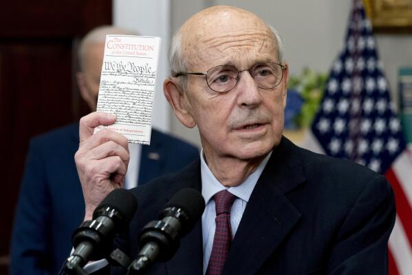 Supreme Court Associate Justice Stephen Breyer holds up a copy of the United States Constitution as he announces his retirement in the Roosevelt Room of the White House in Washington, Thursday, Jan. 27, 2022. (AP Photo/Andrew Harnik)