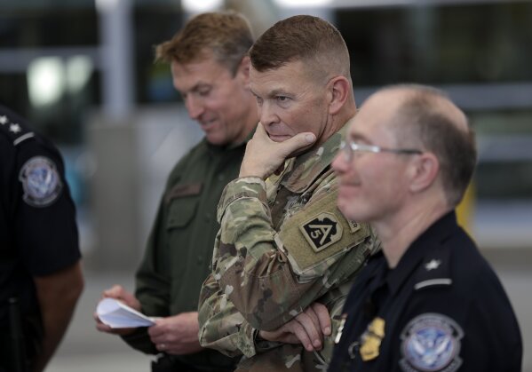 
              U.S. Army Lt. General Jeffrey Buchanan, center, looks on during a tour of the San Ysidro Port of Entry Friday, Nov. 9, 2018, in San Diego. The military is expected to have the vast majority of the more than 7,000 troops planned for the mission along the border deployed by Monday, and that number could grow. (AP Photo/Gregory Bull)
            