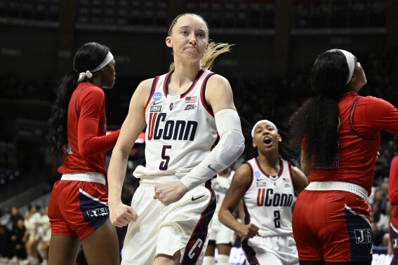 UConn guard Paige Bueckers (5) flexes after making a basket while fouled in the first half of a first-round college basketball game against Jackson State in the NCAA Tournament, Saturday, March 23, 2024, in Storrs, Conn. (AP Photo/Jessica Hill)